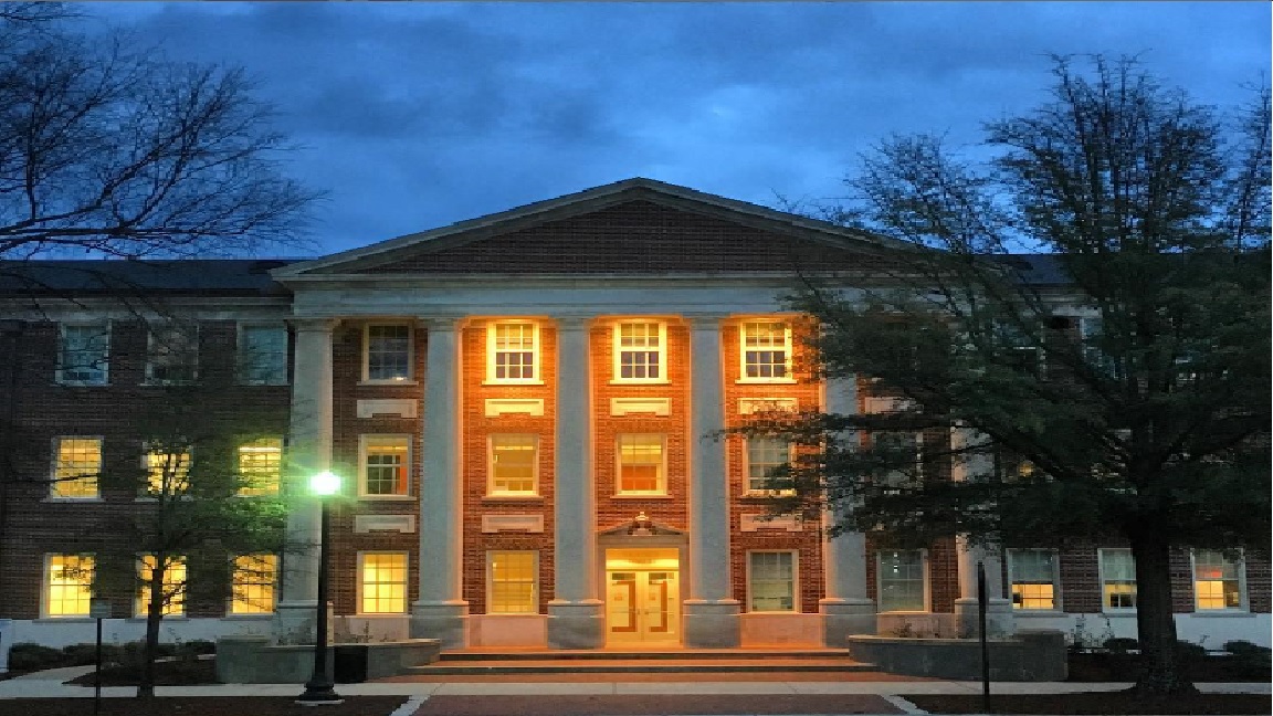 The front of Houser Hall in the evening